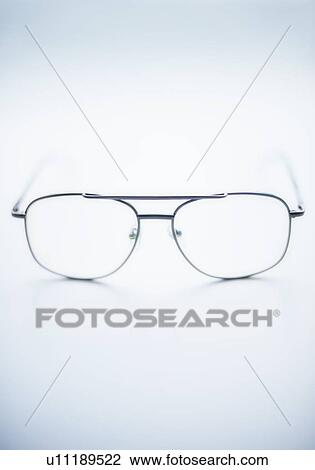 Close up of glasses on blue background, studio shot View Large Photo Image Stock Image - Close up of glasses on blue background, studio shot. Fotosearch
