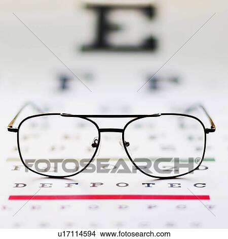 Close up of glasses on eye chart, studio shot View Large Photo Image Picture - Close up of glasses on eye chart, studio shot. Fotosearch