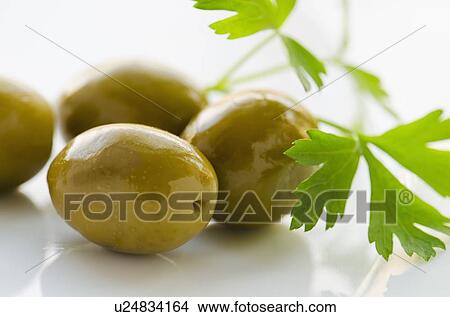 Close-up of green olives with fresh parsley, studio shot View Large Photo Image Picture - Close-up of green olives with fresh parsley, studio shot. Fotosearch