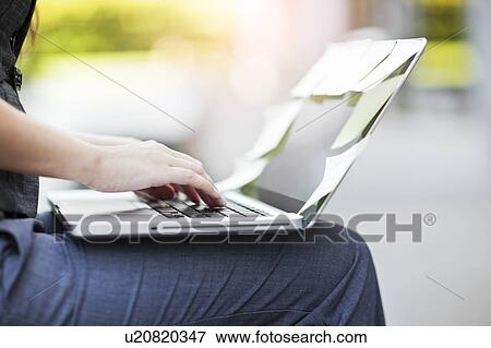 Close-up of hands of businesswoman using laptop View Large Photo Image Stock Photo - Close-up of hands of businesswoman using laptop. Fotosearch