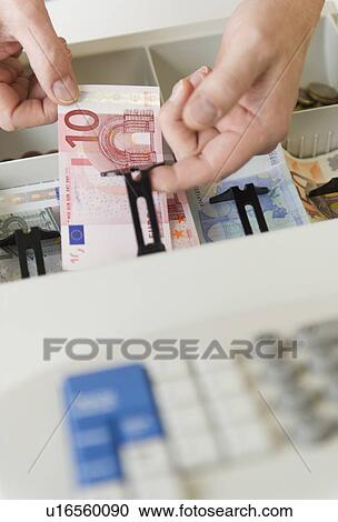Close up of man's hand putting banknotes into cash register, studio shot View Large Photo Image Stock Image - Close up of man's hand putting banknotes into cash register, studio shot. Fotosearch