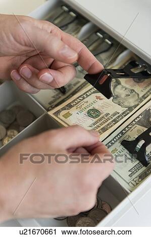Close up of man's hand putting banknotes into cash register, studio shot View Large Photo Image Stock Image - Close up of man's hand putting banknotes into cash register, studio shot. Fotosearch