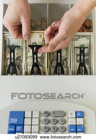 Close up of man's hand putting banknotes into cash register, studio shot View Large Photo Image Stock Photo - Close up of man's hand putting banknotes into cash register, studio shot. Fotosearch