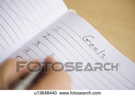 Close up of man's hand writing New Years resolution in notebook, studio shot View Large Photo Image Stock Image - Close up of man's hand writing New Years resolution in notebook, studio shot. Fotosearch