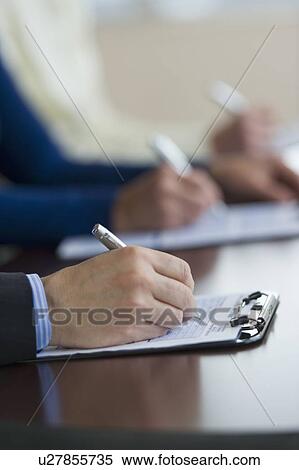 Close up of man's hands filling application form View Large Photo Image Stock Photography - Close up of man's hands filling application form. Fotosearch