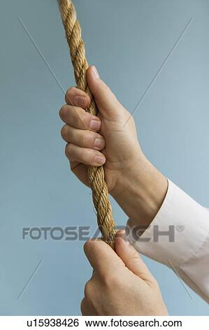 Close up of man's hands pulling rope, studio shot View Large Photo Image Stock Photograph - Close up of man's hands pulling rope, studio shot. Fotosearch