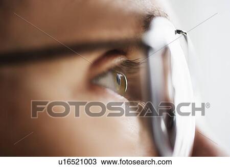 Close up of men's eye looking through glasses View Large Photo Image Stock Image - Close up of men's eye looking through glasses. Fotosearch