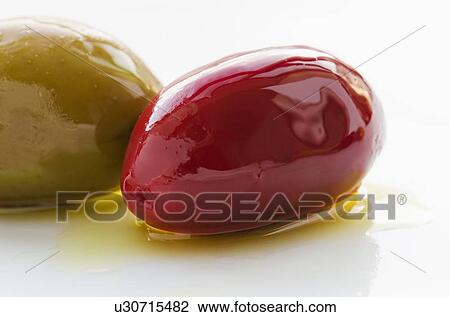 Stock Image - Close-up of olives, studio shot. Fotosearch
