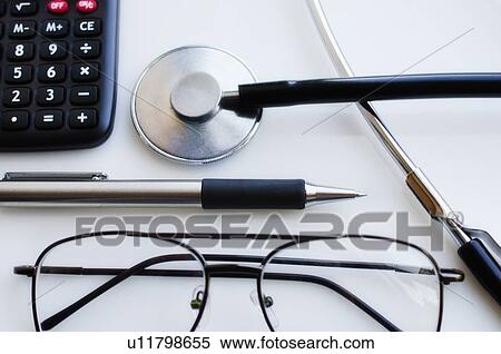 Close up of pen, glasses and calculator and stethoscope, studio shot View Large Photo Image Stock Photography - Close up of pen, glasses and calculator and stethoscope, studio shot. Fotosearch