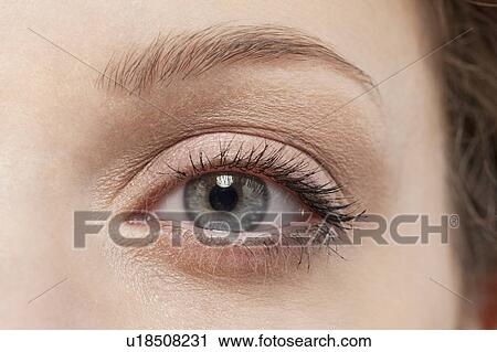 Stock Image - Close up of woman's eye, studio shot. Fotosearch