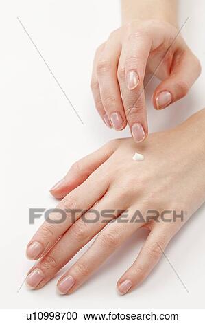 Close up of woman's hands applying moisturizer, studio shot View Large Photo Image Stock Image - Close up of woman's hands applying moisturizer, studio shot. Fotosearch