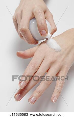 Close up of woman's hands applying moisturizer, studio shot View Large Photo Image Stock Image - Close up of woman's hands applying moisturizer, studio shot. Fotosearch