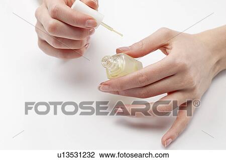 Close up of woman's hands holding nail polish, studio shot View Large Photo Image Stock Image - Close up of woman's hands holding nail polish, studio shot. Fotosearch