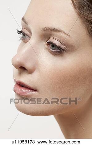 Stock Photo - Close up of young woman's face, studio shot. Fotosearch