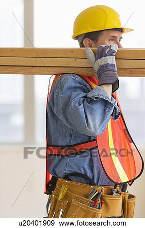 Construction worker carrying planks View Large Photo Image Stock Photo - Construction worker carrying planks. Fotosearch