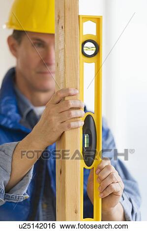Construction worker with level View Large Photo Image Stock Photograph - Construction worker with level. Fotosearch