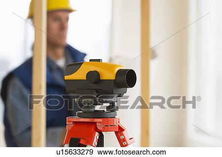 Stock Photo - Construction worker with theodolite. Fotosearch