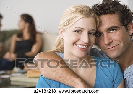 Stock Photo - Couple at home party. Fotosearch