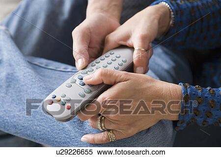 Stock Photography - Couple fighting for remote control. Fotosearch