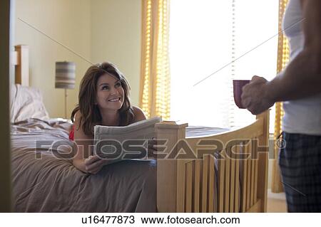 Stock Image - Couple in bedroom. Fotosearch