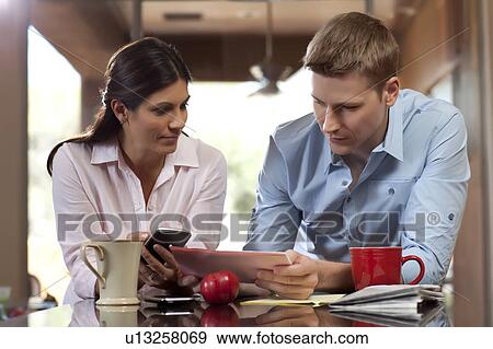 Couple looking at tablet pc View Large Photo Image Stock Photo - Couple looking at tablet pc. Fotosearch