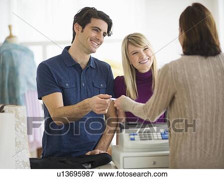 Couple paying with credit card View Large Photo Image Stock Photo - Couple paying with credit card. Fotosearch