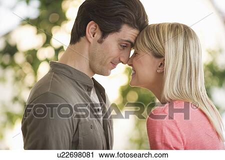 Stock Image - Couple rubbing with noses. Fotosearch