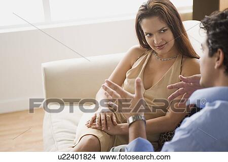 Couple taking at sofa View Large Photo Image Picture - Couple taking at sofa. Fotosearch