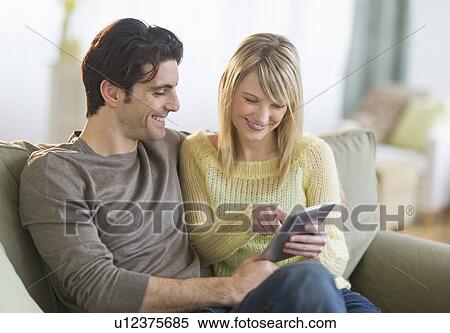 Couple using digital tablet View Large Photo Image Stock Photography - Couple using digital tablet. Fotosearch