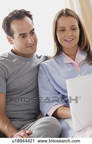 Couple using laptop View Large Photo Image Stock Image - Couple using laptop. Fotosearch