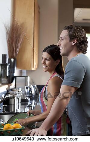 Stock Image - Couple washing dishes. Fotosearch