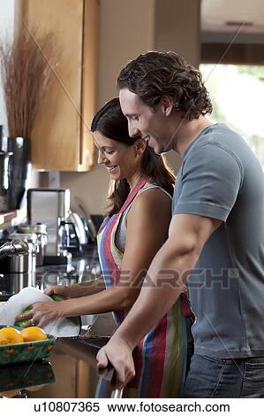 Stock Photography - Couple washing dishes. Fotosearch