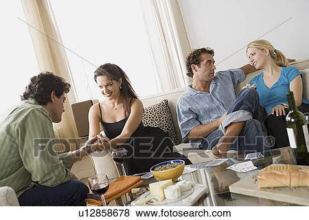 Couples on sofa at home party View Large Photo Image Stock Photo - Couples on sofa at home party. Fotosearch