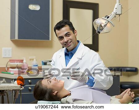 Dentist and patient in dental surgery View Large Photo Image Picture - Dentist and patient in dental surgery. Fotosearch