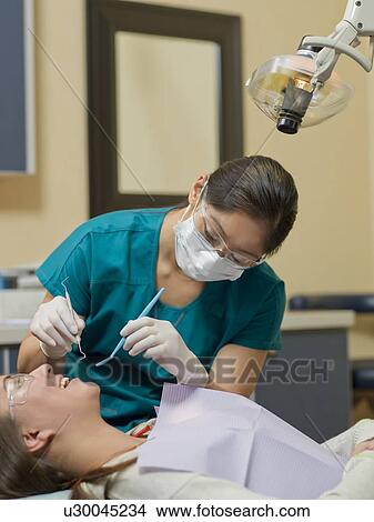 Dentist and patient in dental surgery View Large Photo Image Picture - Dentist and patient in dental surgery. Fotosearch