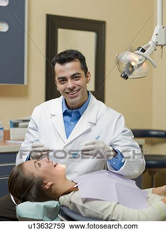Dentist and patient in dental surgery View Large Photo Image Stock Photo - Dentist and patient in dental surgery. Fotosearch