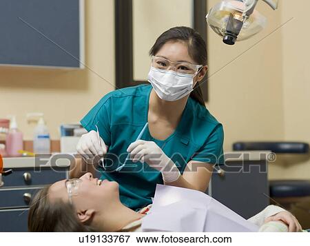 Stock Photo - Dentist and patient in dental surgery. Fotosearch