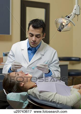 Dentist and patient in dental surgery View Large Photo Image Stock Photo - Dentist and patient in dental surgery. Fotosearch
