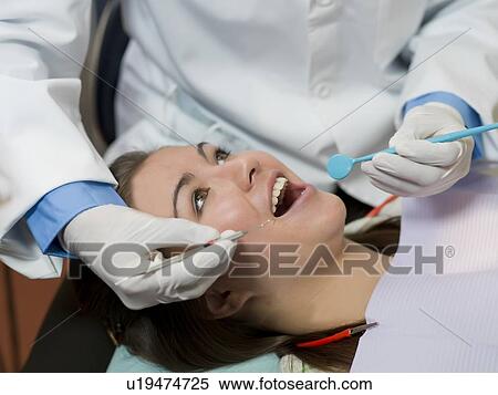 Dentist and patient in dental surgery View Large Photo Image Stock Photography - Dentist and patient in dental surgery. Fotosearch