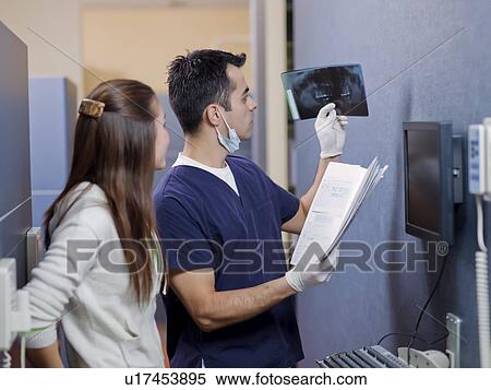 Stock Photography - Dentist and patient looking at x-ray . Fotosearch