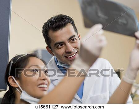 Dentists checking x-ray image View Large Photo Image Stock Photo - Dentists checking x-ray image. Fotosearch