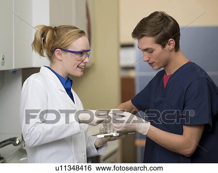 Stock Photograph - Dentists in dental surgery. Fotosearch