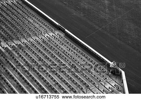 Stock Photography - Distant view of couple and stadium bleachers. Fotosearch