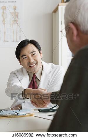 Doctor and patient shaking hands View Large Photo Image Stock Image - Doctor and patient shaking hands. Fotosearch