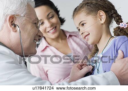 Doctor examining girl (10-11) View Large Photo Image Picture - Doctor examining girl (10-11). Fotosearch
