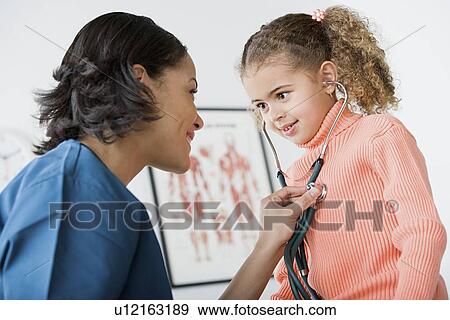 Doctor examining girl (10-11) View Large Photo Image Stock Photo - Doctor examining girl (10-11). Fotosearch