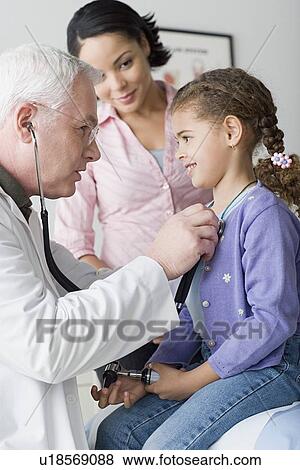 Doctor examining girl (10-11) View Large Photo Image Stock Photo - Doctor examining girl (10-11) . Fotosearch