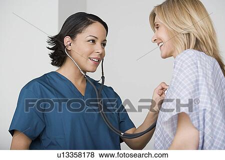 Stock Photo - Doctor examining patient. Fotosearch