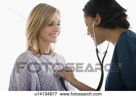 Stock Photo - Doctor examining patient. Fotosearch