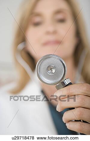 Doctor holding stethoscope View Large Photo Image Stock Photo - Doctor holding stethoscope. Fotosearch
